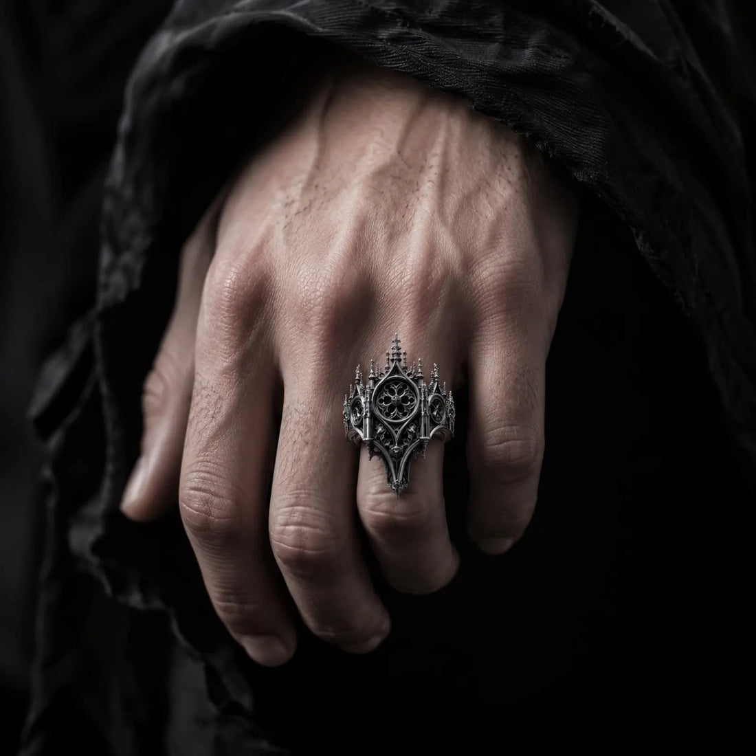 Hand wearing a gothic cathedral rose window ring — alternative engagement ring in oxidized 925 sterling silver