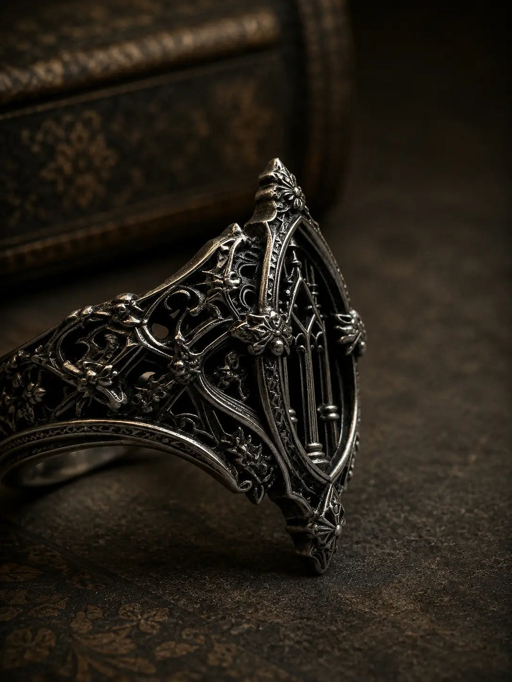 Close-up of gothic cathedral ring — oxidized recesses and carved gargoyle band in sterling silver