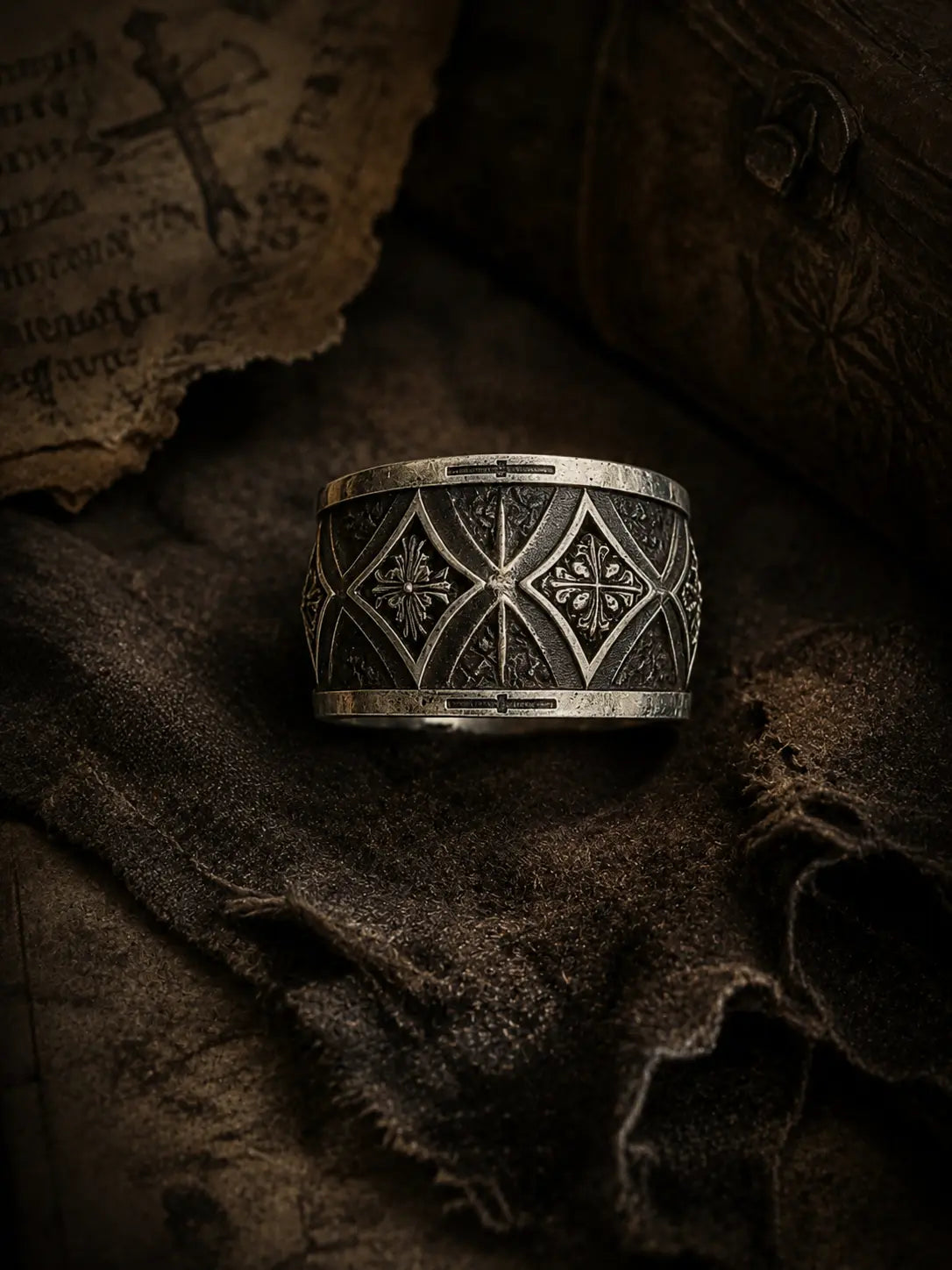 Gothic cross armor band close-up — interlocking pointed arches and deeply recessed cross motif in sterling silver