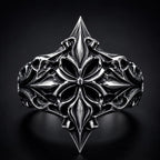 Lozenge shield ring close-up — heraldic fleur-de-lis cross motif in deep-relief oxidized sterling silver