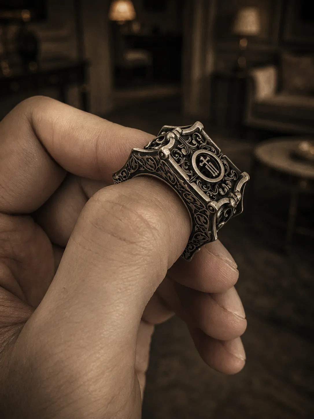 Gothic cross signet ring close-up — deeply carved architectural shoulders and classical acanthus foliage