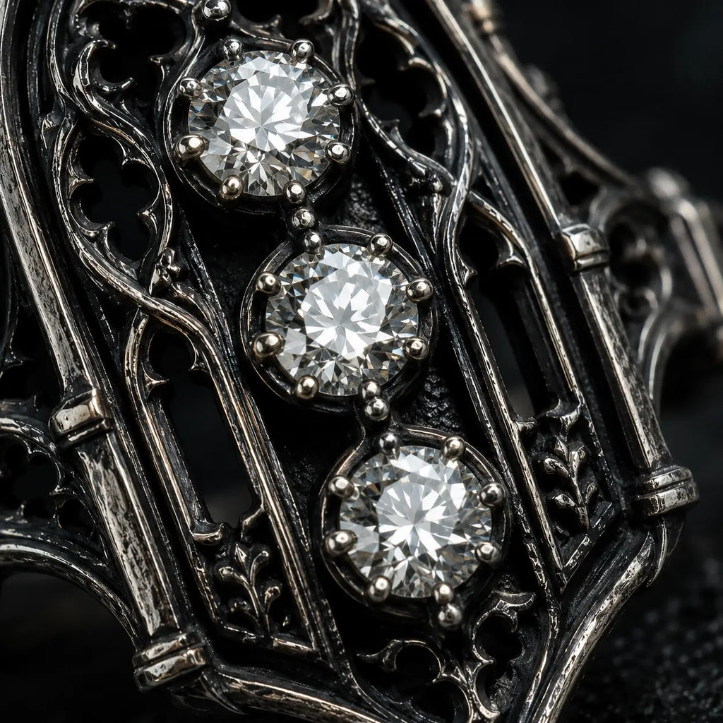 Close-up of an ornate metal object with three diamonds embedded in it. moissanite, Victorian, oxidized silver
