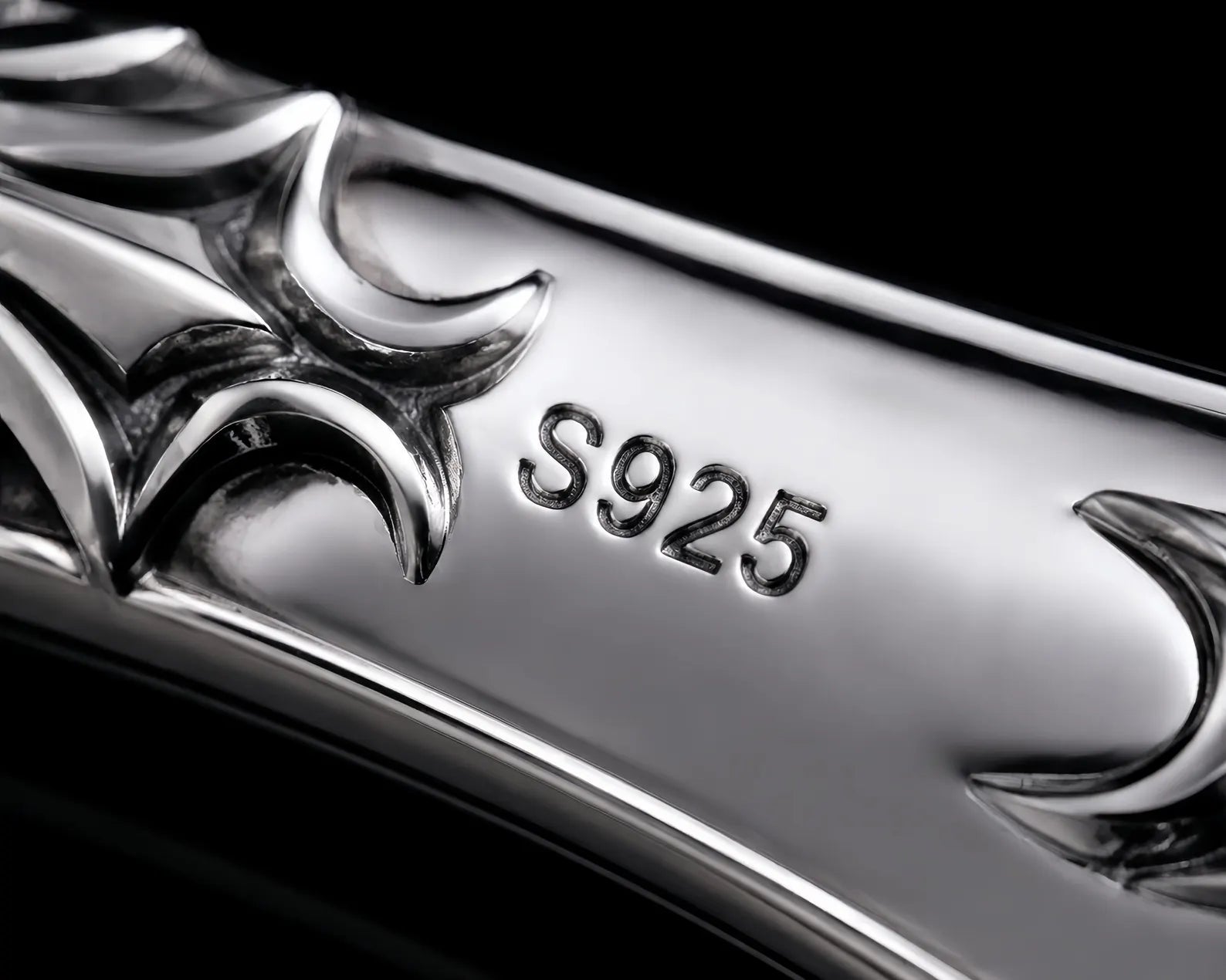 Macro close-up of the sterling silver handle showing the S925 hallmark and cyber-sigilism cutouts