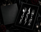 Cyber Baroque cutlery set presented in a black gift box on dark roses — luxury gothic tableware gift