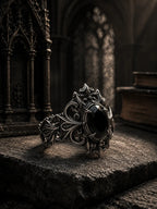 Cathedral crest ring with black onyx gemstone — hand-oxidized scrollwork and gothic architectural band